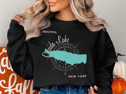 Black sweatshirt with a teal outline of Oneida Lake and a compass rose.