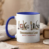 White mug with blue handle featuring lake life graphic and text.