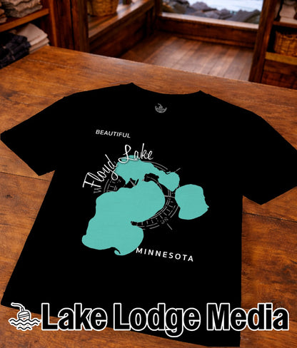 Black t-shirt with teal map outline of Lake Flond and "Lake Lodge Media" text.