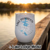 White stainless steel tumbler with a Lake Disharoon Georgia graphic resting on a wooden dock at sunset.