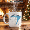 White mug with "Rushford Lake New York" design, steam, and splashing liquid.