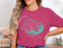 Pink t-shirt with a compass rose and Wright Patman Lake, Texas map graphic.
