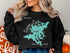 Black sweatshirt with a teal map of Squam Lake, New Hampshire.