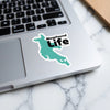 Turquoise map sticker with black text "Newfound Life" on a laptop.