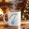 White mug with Folsom Lake map and compass, near a fireplace and Christmas tree.