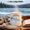 White mug with Lake Rayburn Arkansas design sits on a window sill with a book.