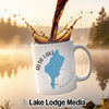 White mug with "Alta Lake Washington" map and compass design, coffee pouring.