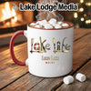 White mug with red handle, filled with hot chocolate and marshmallows, featuring "Lake Life Maine" design.
