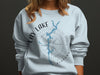Light blue sweatshirt with Lay Lake Alabama design and compass graphic.