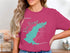 Teal Barnett Lake outline with compass rose on a woman's pink t-shirt.