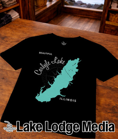 Black t-shirt with teal Carlyle Lake map and compass, "Illinois" text, and "Lake Lodge Media" logo.