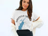 White t-shirt with "Saratoga Lake New York" text and map graphic.