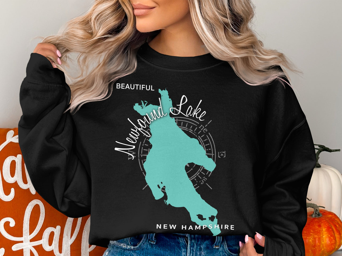 Black sweatshirt with turquoise Newfound Lake map and compass rose design.