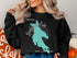Black sweatshirt with turquoise Newfound Lake map and compass rose design.