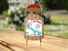 Sled ornament with "Merry Christmas From Lake O' The Pines" text and snowflake graphics.