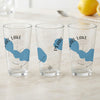 Three clear glasses featuring blue Pearl Lake maps and compass rose designs.