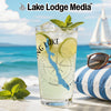 Glass with refreshing drink, limes, mint, and compass graphic on beach background.