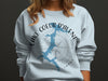 Light blue sweatshirt with "Lake Coeur d'Alene Idaho" and compass graphic.
