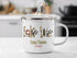 Enamel mug with "Lake Travis Texas" in nautical graphics, steaming.