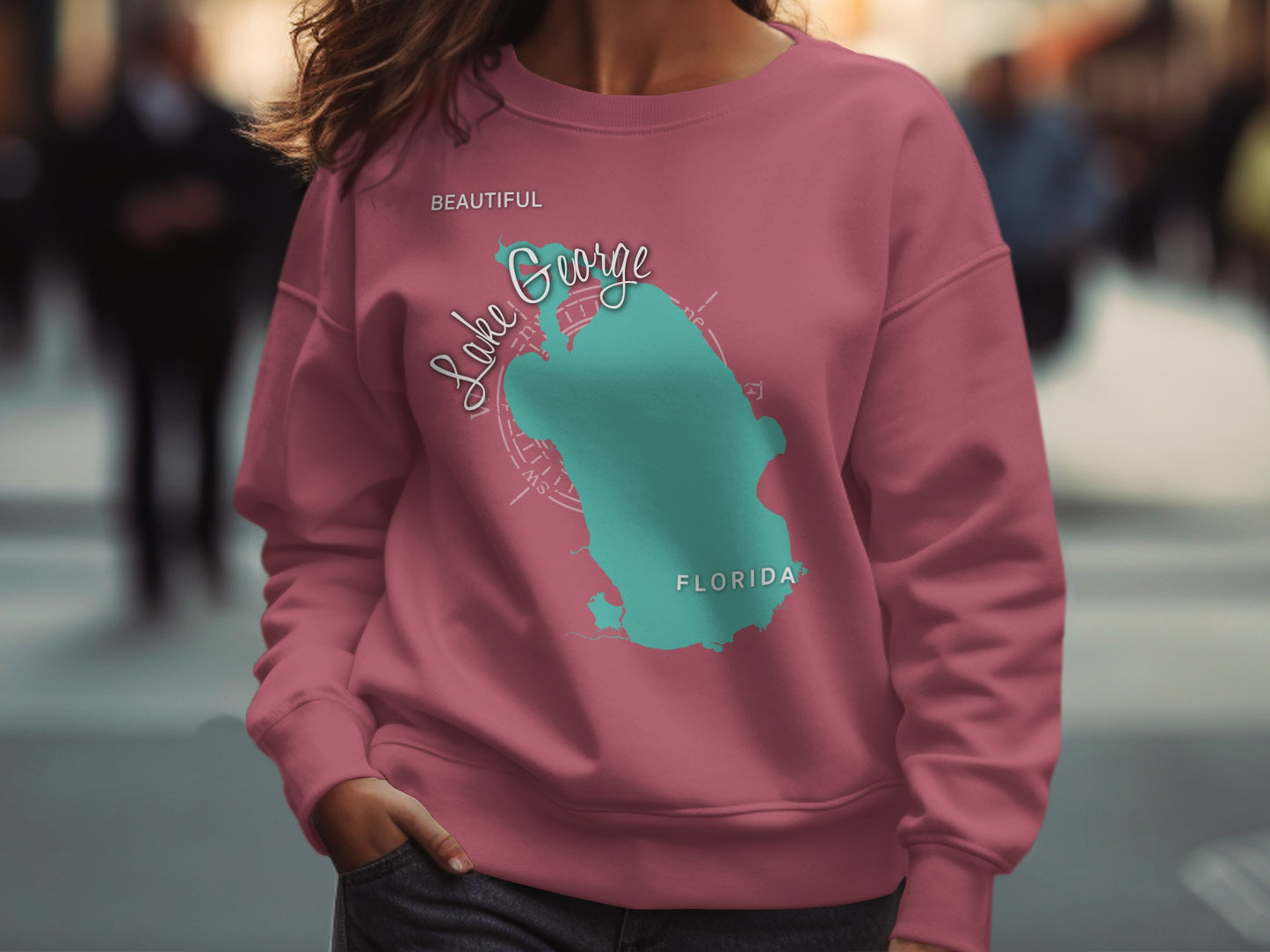 Pink sweatshirt with teal map of Lake George, Florida and text.