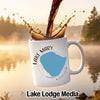 White mug with "Lake Mary Minnesota" map graphic, with coffee splashing into it.