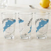 Three clear glasses each feature a blue map of American Lake and a compass rose.