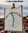 Man holding a blanket with Lake Blackshear Georgia map and compass design.
