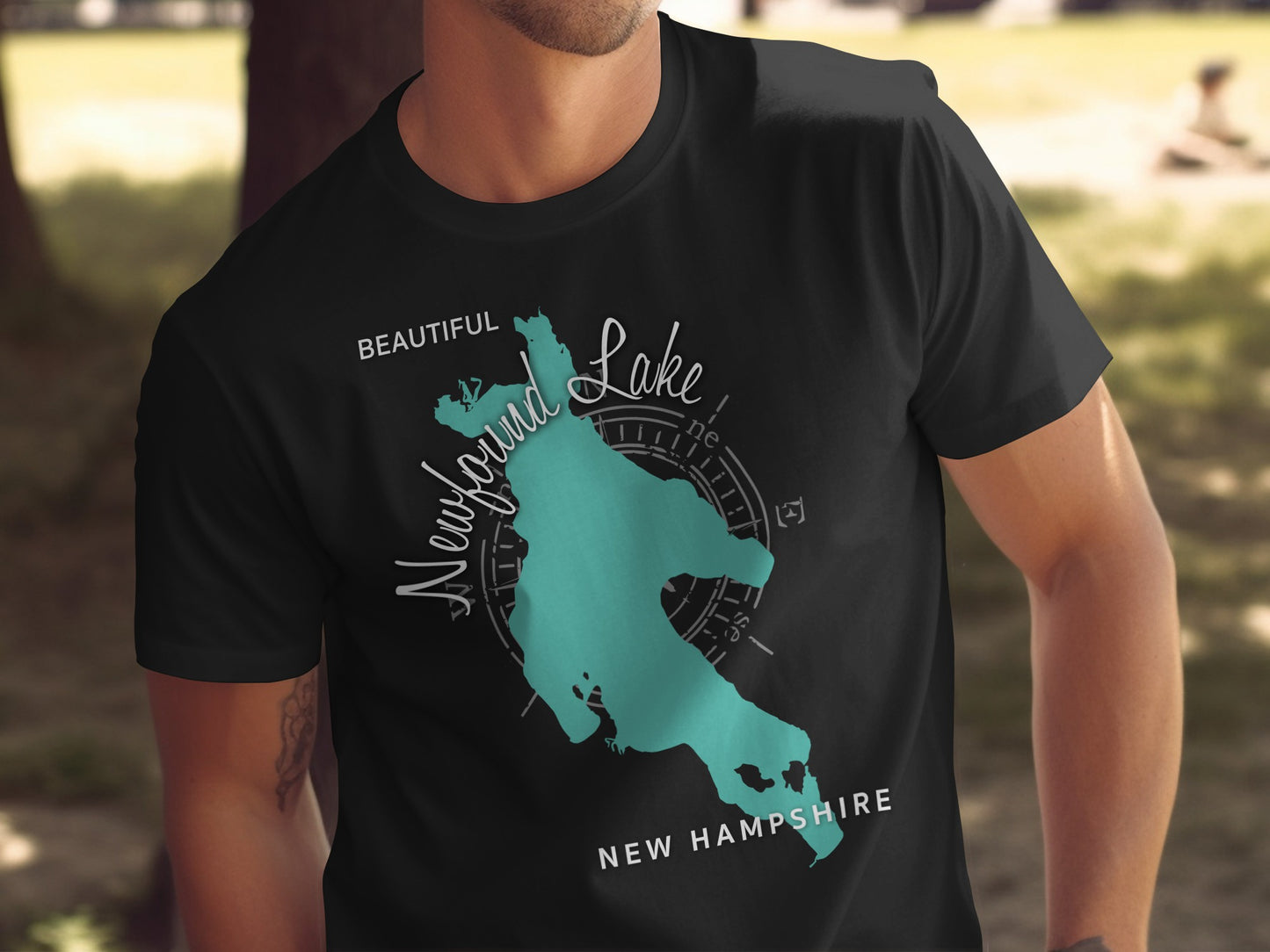 Black t-shirt with teal map graphic of Newfound Lake, New Hampshire.