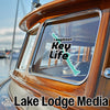Longboat Key Life sticker on a boat window with Lake Lodge Media logo.