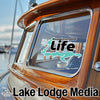 Boat window graphic with "Ossawinamakee Life" and "Lake Lodge Media" text.