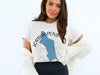 White t-shirt with "Jordan Pond Maine" text and blue outline of a pond.