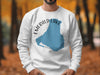 White sweatshirt with blue Emerald Lake Canada map and compass design.