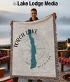 Woven throw blanket featuring Torch Lake Michigan map and compass design.