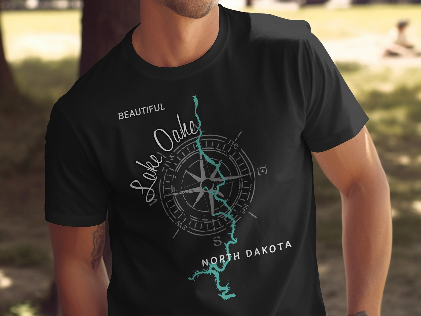 Black t-shirt with "Beautiful Lake Oahe, North Dakota" text and compass graphic.