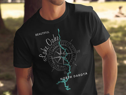 Black t-shirt with "Beautiful Lake Oahe, North Dakota" text and compass graphic.