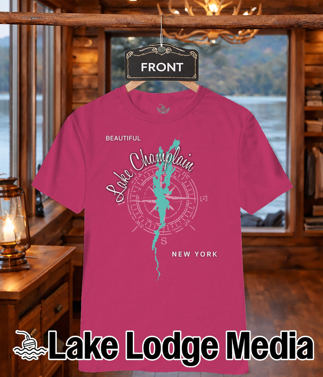 Pink t-shirt with Lake Champlain compass design and "Lake Lodge Media" text.