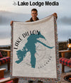 Woven blanket with Lake Dillon map and compass design, held by a man.