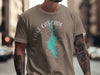 Taupe t-shirt with white text and teal lake graphic.