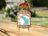 Sled ornament with text "Merry Christmas from Lake Latonka" and snowflakes.