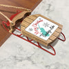 Wooden sled ornament with red runners and rope, featuring "Merry Christmas From Saratoga Lake."