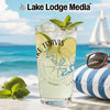 Glass with Lake Travis map, lime, and mint on a beach with sailboat.