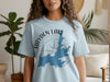 Light blue t-shirt with "Hayden Lake Idaho" map and compass graphic.