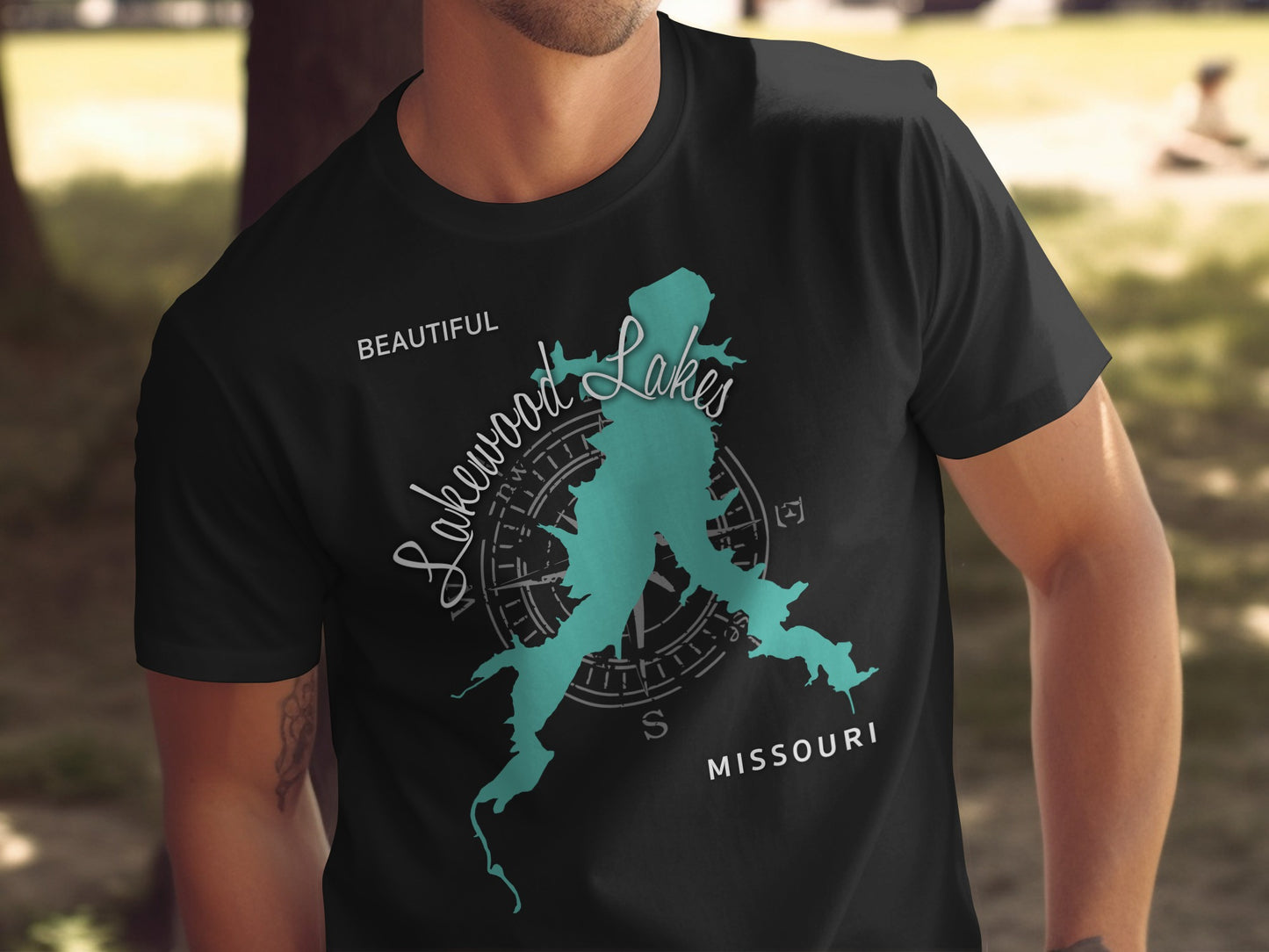 Black t-shirt with a teal map outline and compass rose graphic.