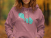 Pink hoodie with a teal outline of Pearl Lake, Wisconsin and compass design.