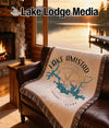 Woven blanket with Lake Amistad map and compass design on a sofa.