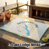 A rectangular glass cutting board featuring a Saylorville Lake, Iowa map design sits on a wooden outdoor bar.