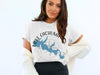 White t-shirt with blue Lake Cachuma map graphic and compass rose.