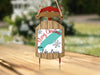 Sled ornament with "Merry Christmas FROM Lake Louise" and snowflakes.