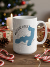 White mug with Augur Lake, New York map and compass graphic.