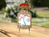 Sled ornament with "Merry Christmas FROM Lake Memphremagoo" text and snowflakes.